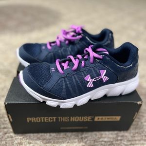Size 4.5 purple and black Under Armour sneakers for big girls.